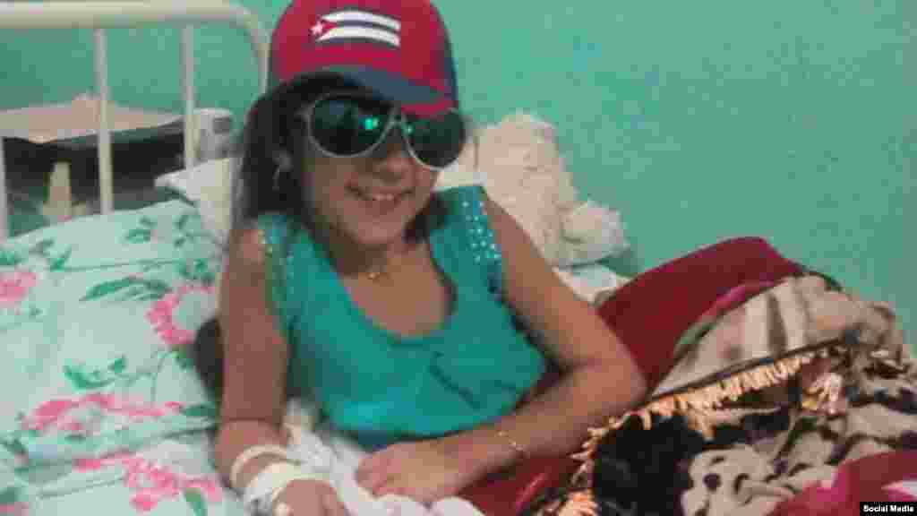 La pequeña no pierde la alegría y en esta foto juega con las gafas y gorra de un familiar.