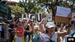 Un grupo de personas participa en una protesta por las carencias en el suministro de agua hoy, sábado 4 de agosto de 2018, en Caracas