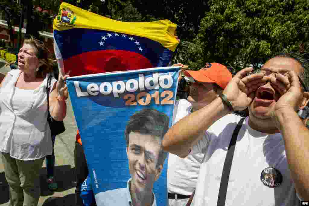 Un grupo de personas grita consignas y sostienen un afiche del líder opositor venezolano Leopoldo López. 