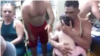 La pequeña en brazos de uno de los cubanos acorralados en el buque MV Bulk Freedom.