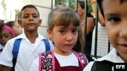 Tres niños posan con una bandera cubana durante el primer día del curso escolar 2015-2016 hoy, martes 1 de septiembre de 2015, en La Habana (Cuba). Cuba comienza hoy el curso escolar 2015-2016 con cerca de dos millones de estudiantes en más de 10.300 esc