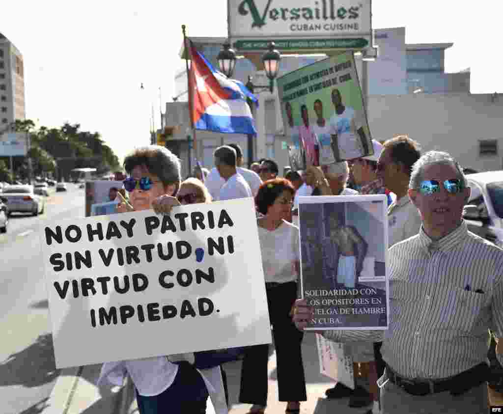 Varios cubanos sostienen carteles con fotos de Fariñas y banderas cubanas durante una vigilia realizada hoy, miércoles 27 de julio 2016, frente al Restaurante Versailles en Miami.